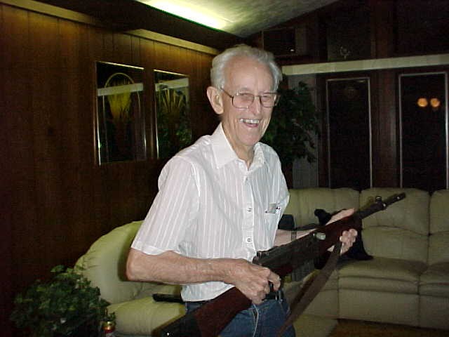 Dad holding one of Arlyn's guns, summer 2001 in Percy